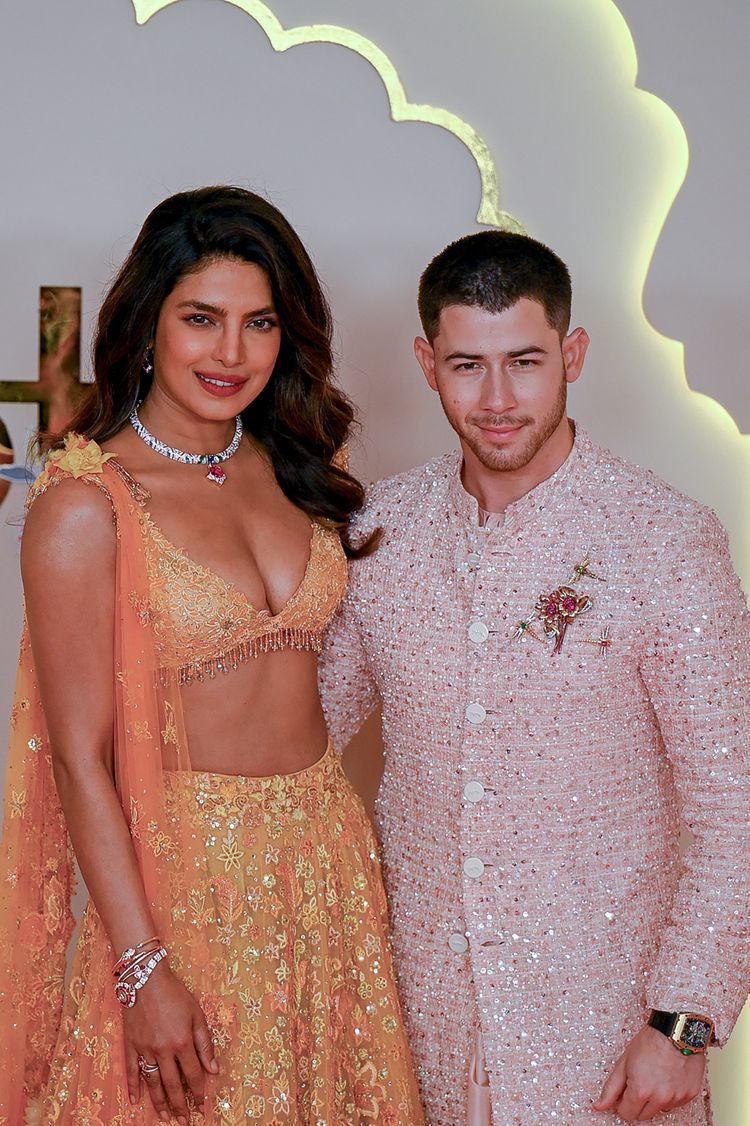 Bollywood actress Priyanka Chopra Jonas (L) and her husband American singer-songwriter and actor Nick Jonas (R) pose for photos as they arrive to attend the wedding ceremony of billionaire tycoon and Chairman of Reliance Industries Mukesh Ambani's son Anant Ambani and Radhika Merchant in Mumbai on July 12, 2024. Socialite sisters Kim and Khloe Kardashian were among the global celebrities spotted in India on July 12 to attend a lavish three-day wedding ceremony staged by Asia's richest man Mukesh Ambani.